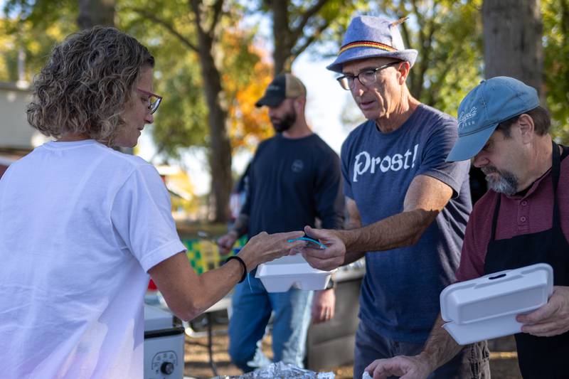 A visitor buys a sausage at the annual Harvest Fest on Saturday, Oct. 19, 2024, at Kirby Park in Spring Valley.