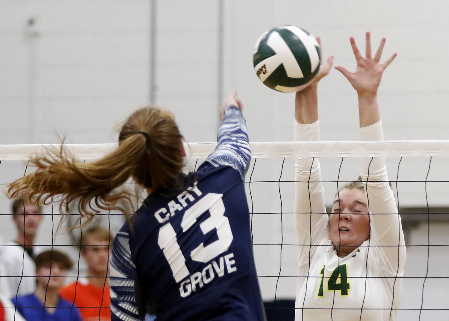 Cary-Grove’s Tricia Kennedy, right, tries to hit the ball past Crystal Lake South’s Emma Stowasser, left, during a Fox Valley Conference volleyball match Thursday, Aug. 25, 2022, between Cary-Grove and Crystal Lake South at Cary-Grove High School.