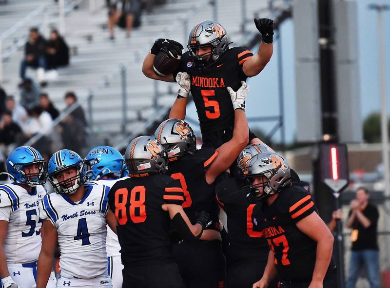 Minooka's Tyler Minda (5) celebrate after scoring a touchdown during the non-conference game against St. Charles North on Friday, Aug. 29, 2025, at Minooka.
