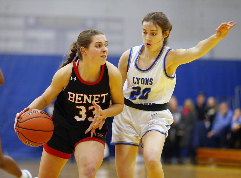 Benet's Magdalena Sularski (33) drives to the basket against Lyons' Ella Ormsby (20) during the girls varsity basketball game between Benet Academy and Lyons Township on Wednesday, Nov. 30, 2022 in LaGrange, IL.