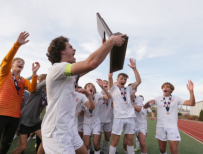 Members of the Timothy Christian soccer team hoist the Class 1A State soccer third place trophy after defeating Wheaton Academy on Saturday, Oct. 29, 2022 at EastSide Centre in Peoria.