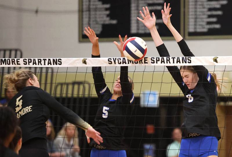 Burlington Central's Emily Maramba (left) and Ainsley Wilson block Sycamore's Kylie Walsh Tuesday, Oct. 29, 2024, during their Class 3A regional match at Sycamore High School.