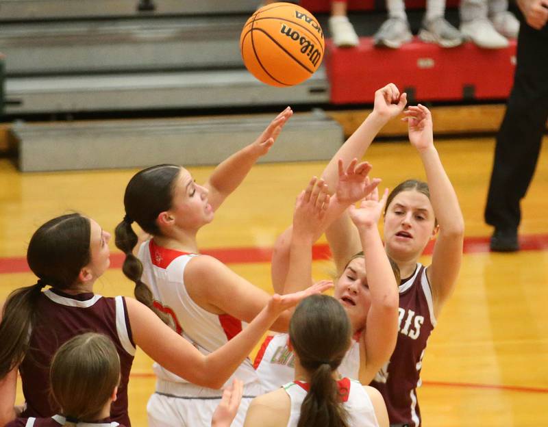 (From left) Morris's Lily Hansen, L-P's Brianna Ruppert and teammate Emma Jereb and Morris's Alyssa Jepson grab a rebound on Friday, Dec. 6, 2024 in Sellett Gymnasium at L-P High School.