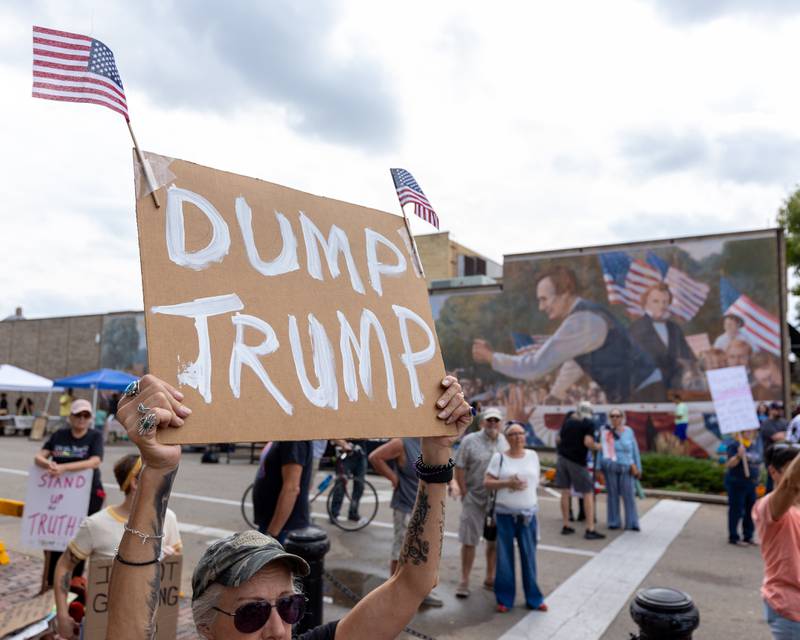 Protester holds sign above head at the ‘No Kings 2.0’ Protest on Saturday, October 18, 2025 at Washington Square Park in Ottawa.