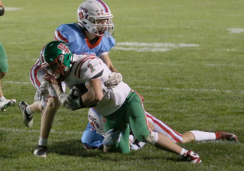 L-P's Noah Zebron is taken down by Ottawa's George Shumway and teammate Logan Mills on Friday, Oct. 4, 2024 at King Field.