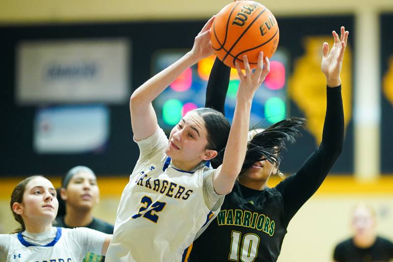 Aurora Central Catholic's Brooklyn Murphy (22) and Waubonsie Valley's Danyella Mporokoso (10) fight for a rebound during a basketball game at Aurora Central Catholic High School on Thursday, January 30, 2025.