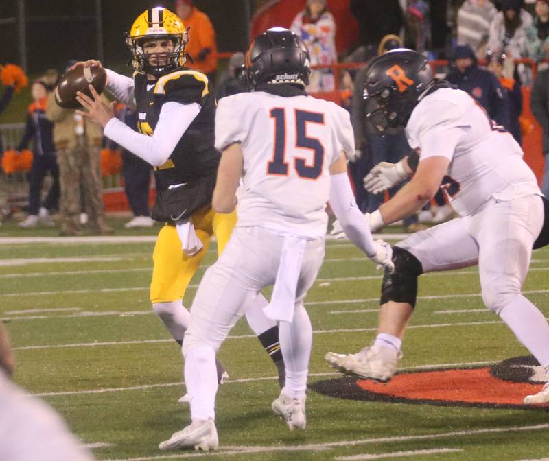 St. Laurence quarterback Evan Les throws a pass as Rochester's Aaron McDannald defends during the Class 4A State football championship on Friday, Nov, 24, 2023 at Hancock Stadium in Normal.