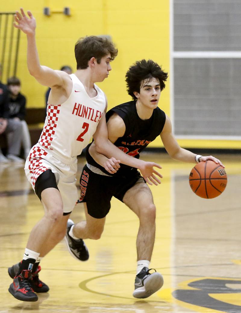 McHenry’s Marko Visnjevac, right, brings the ball up the court against Huntley's John Kramer during a IHSA Class 4A Boys Regional basketball game Wednesday, Feb. 23, 2022, between Huntley and McHenry at Jacobs High School.