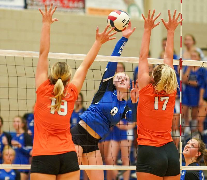Geneva’s Lillian Hallahan (8) goes up for a kill against Wheaton Warrenville South's Cheyenne LaHaye (18) and Rebecca Bellows (17) during a volleyball match at Geneva High School on Tuesday, Sep 5, 2023.