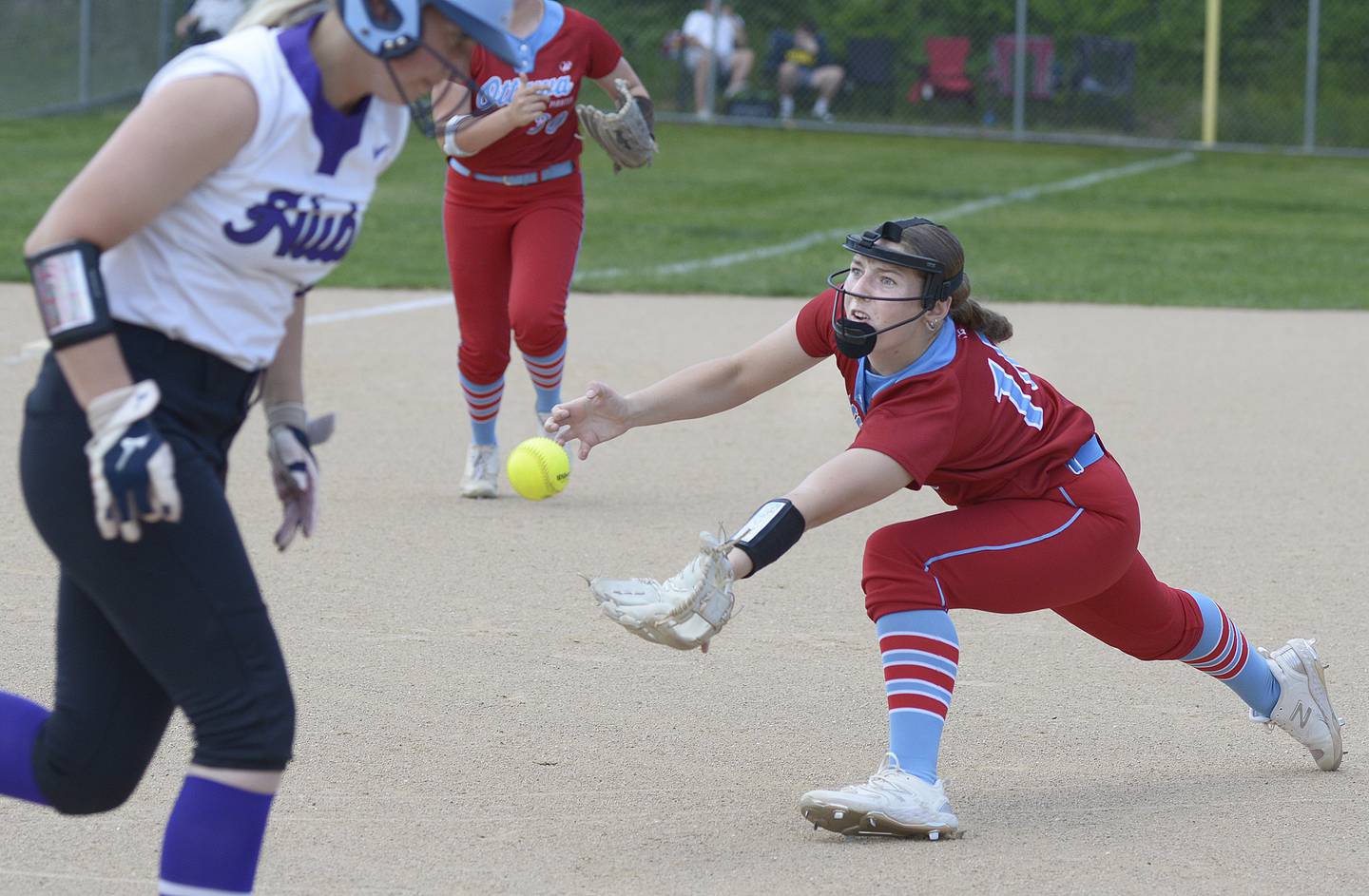Ottawa starting pitcher Addie Russell, leaves the mound to field a ground ball Wednesday against Rochelle at Ottawa.