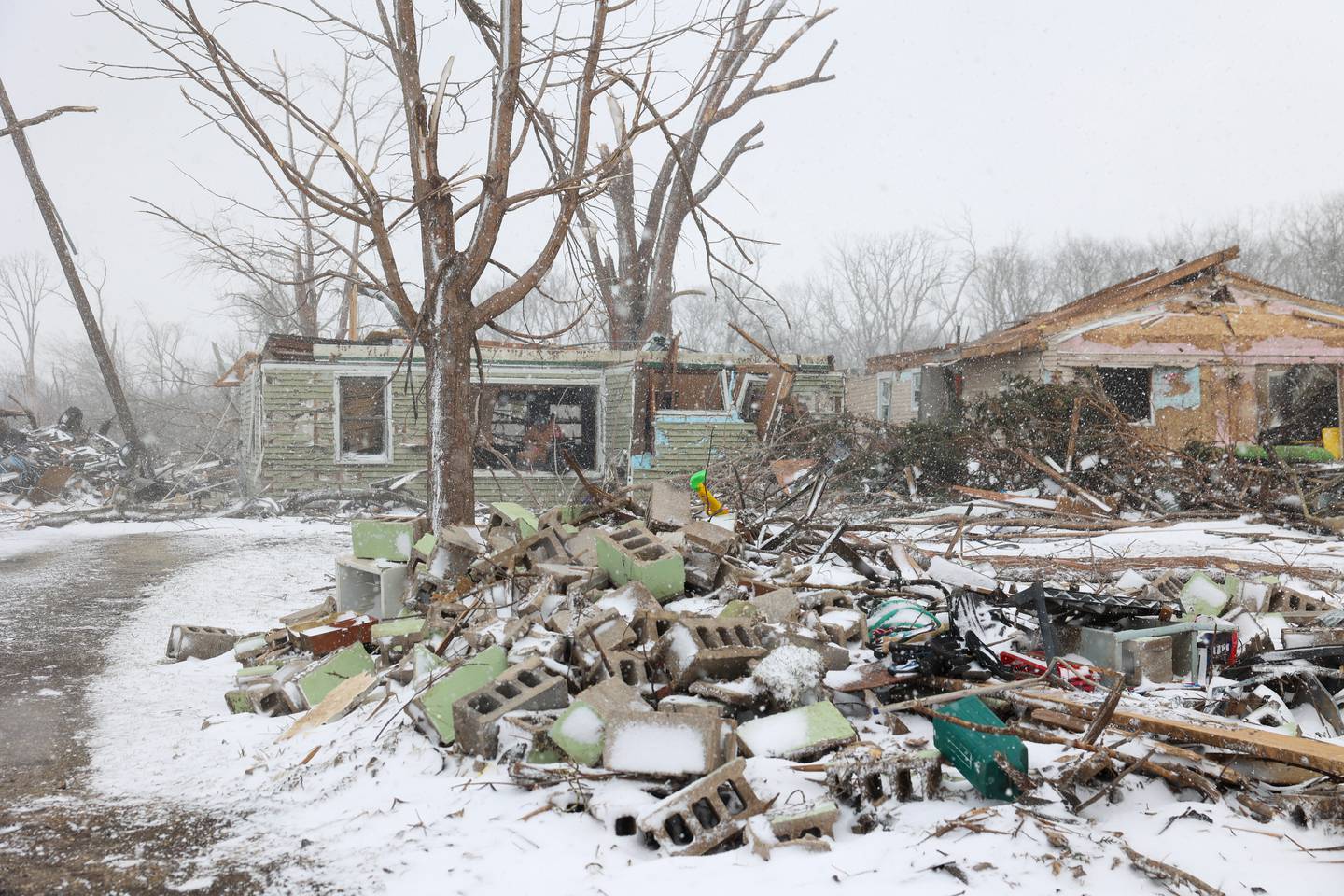 Massive damage is shown to the property of Evanston residents Douglas Weber and Martha Plaza-Weber along South Sandbar Road in Aroma Township on March 16, 2026, following the March 10 tornado in Kankakee County. The home previously had a second story and a garage where the cinder blocks lay.