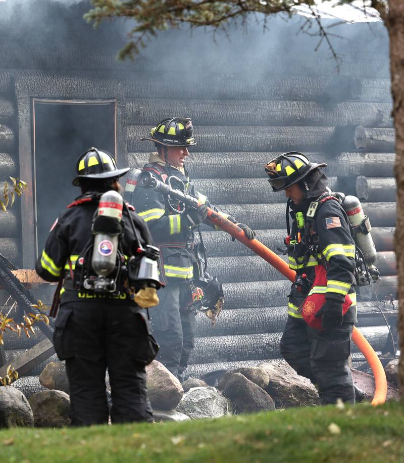 DeKalb firefighters prepare to put water on a house that was destroyed by fire Thursday, Nov. 13, 2025, near Shabbona Grove Road in Shabbona. Several local departments responded to the general alarm structure fire.