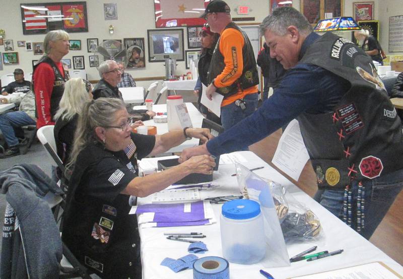 American Legion Riders Post #181 of Sandwich members Sandy Lawrence, Mike Rennels. Cherie Mauer, and Sally Kolb register bikers and offer chances on the many raffle baskets.