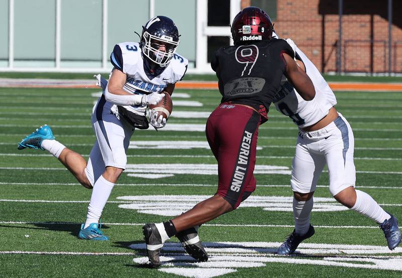 Nazareth's Jaden Fauske looks to get past Peoria's Gary Rutherford during their IHSA Class 5A state championship game Saturday, Nov. 26, 2022, in Memorial Stadium at the University of Illinois in Champaign.