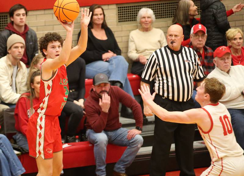 L-P's Mikey Hartman shoots a wide-open jump shot over Ottawa's Evan Snook on Friday, Jan. 10, 2024 in Kingman Gym at Ottawa High School.