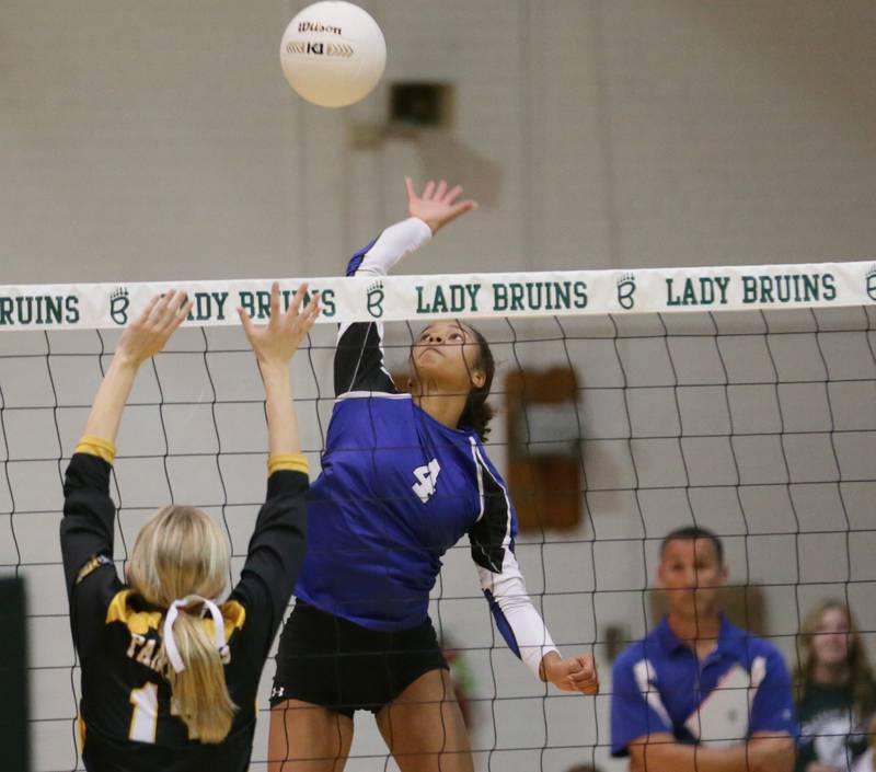 Newark's Kiara Wesseh (4) sends a kill past Putnam County's Maddie Weger (13) in the Class 1A semifinal game on Wednesday, Oct. 16, 2022 at St. Bede Academy in Peru.