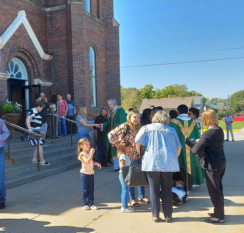The Rev. Monsignor Philip Halfacre greets parishioners as they exit St. Stephen Church for the last time Sunday, Oct. 1, 2023. The church is closing.
