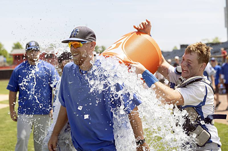 Newman head coach Ken Koerner is given the ice bath after his team won 3-2 over Chicago Hope in the  supersectional baseball game Monday, May 29, 2023.