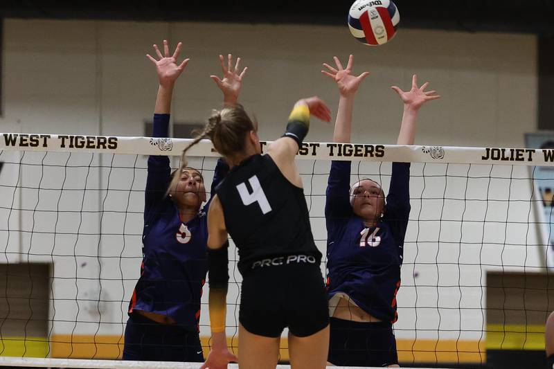 Romeoville’s Gabriela Villanueva, left, and Aubrea Baldwin go for the block against Joliet West on Thursday, Sept. 5, 2024 in Joliet.