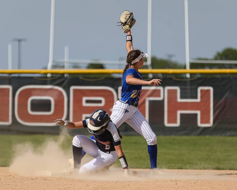 Oswego's Marissa Moffett (5) slides into second while Wheaton North's Reagan Crosthwaite (21) looks for the call  during Class 4A Plainfield North Sectional final softball game between Wheaton North at Oswego. May 31th, 2024.