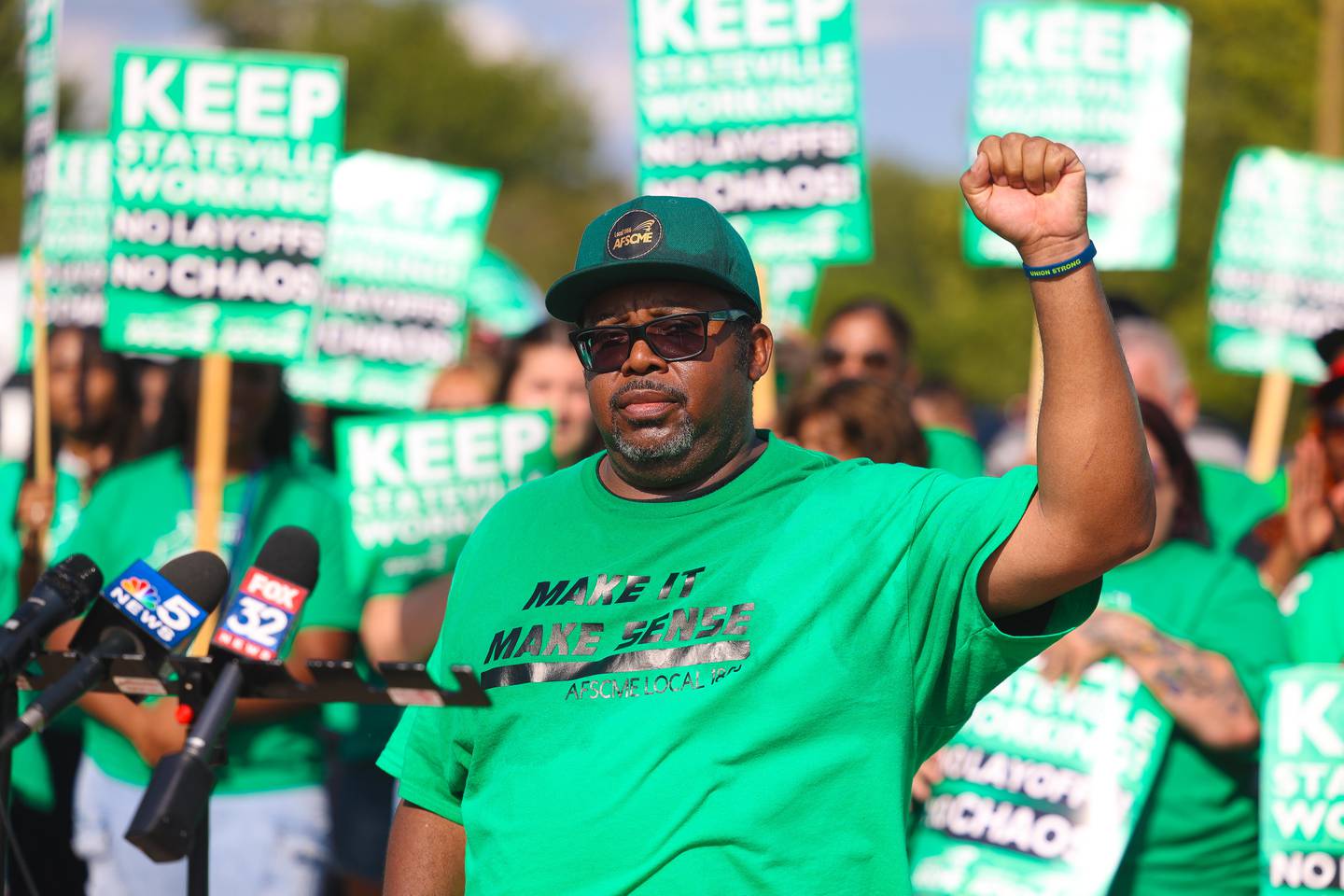 AFSCME Local 1866 President and Stateville employee Eugen Washington holds up his fist in protest before speaking at a picket gathering outside the Stateville Correctional Center on Thursday, August 29, 2024 in Joliet.