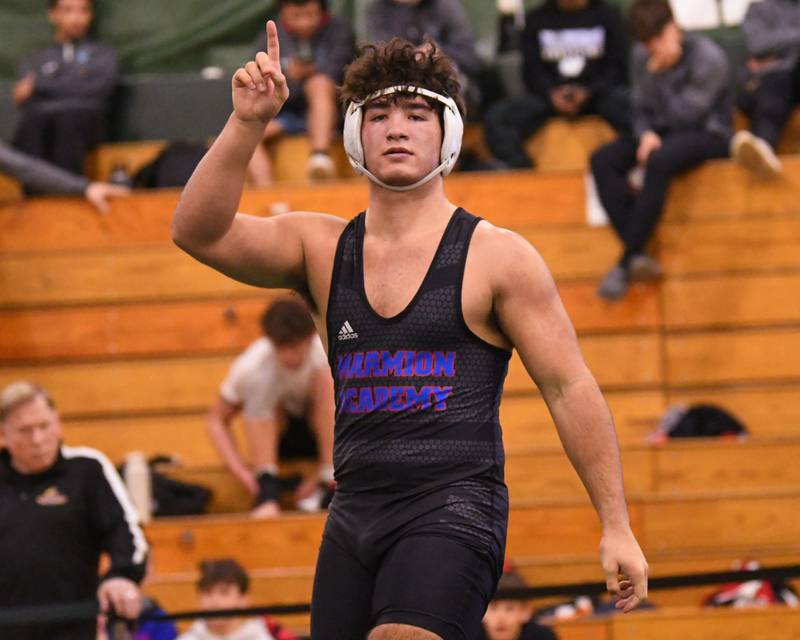 Joseph Favia of Marmion Academy celebrates after winning the regional title match in the 215 weight class on Saturday Feb. 3, 2024 held at Glenbard west High School.