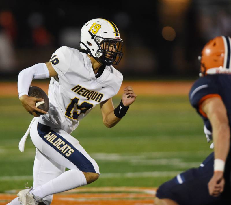 Joe Lewnard/jlewnard@dailyherald.com
Neuqua Valley quarterback Kiet Troung carries the ball during Friday’s game at Naperville North.