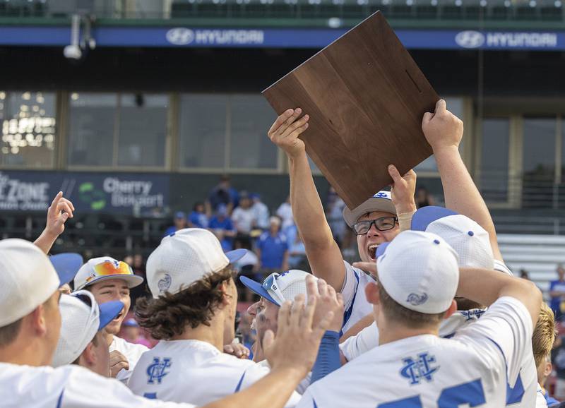 The Newman Comets raise the plaque after beating  Chicago Hope Monday, June 2, 2025, during the Class 2A Supersectional at Northwestern Medicine Field in Geneva.