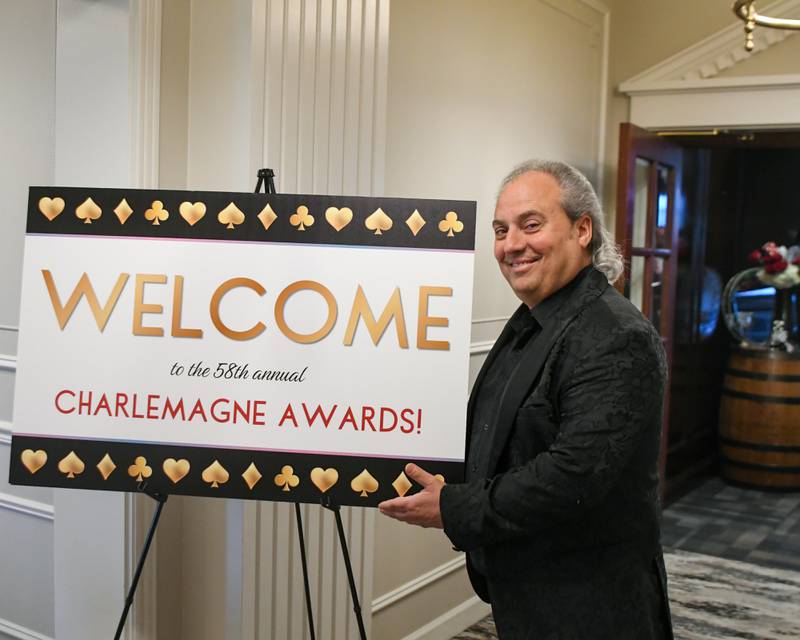 Charlemagne Award nominee Ron Onesti poses with the welcome sign to the awards dinner on Friday, May 1, 2026, in St. Charles.