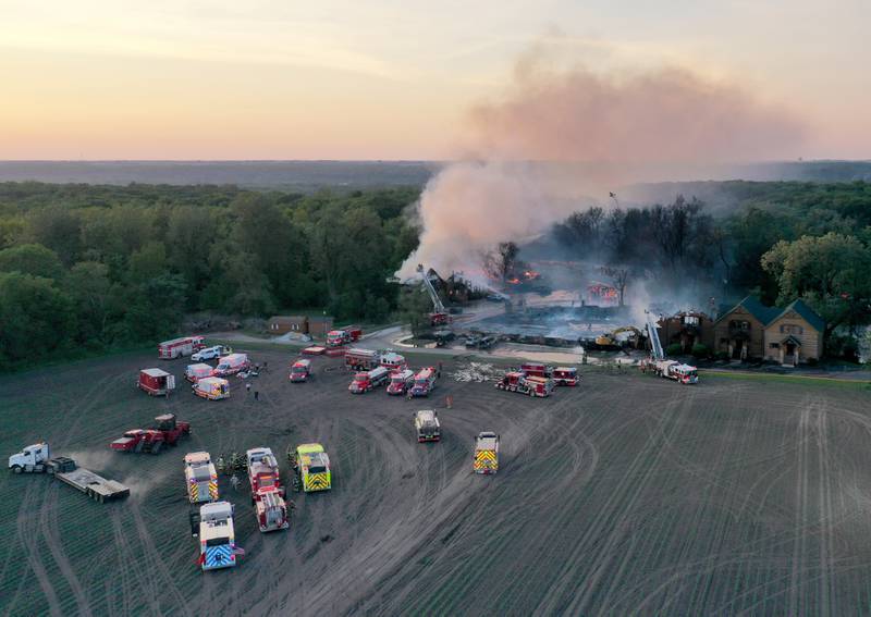 Firefighters fight a five-alarm fire that burned cabins at the Grand Bear Resort on Monday, May 30, 2022 in Utica.