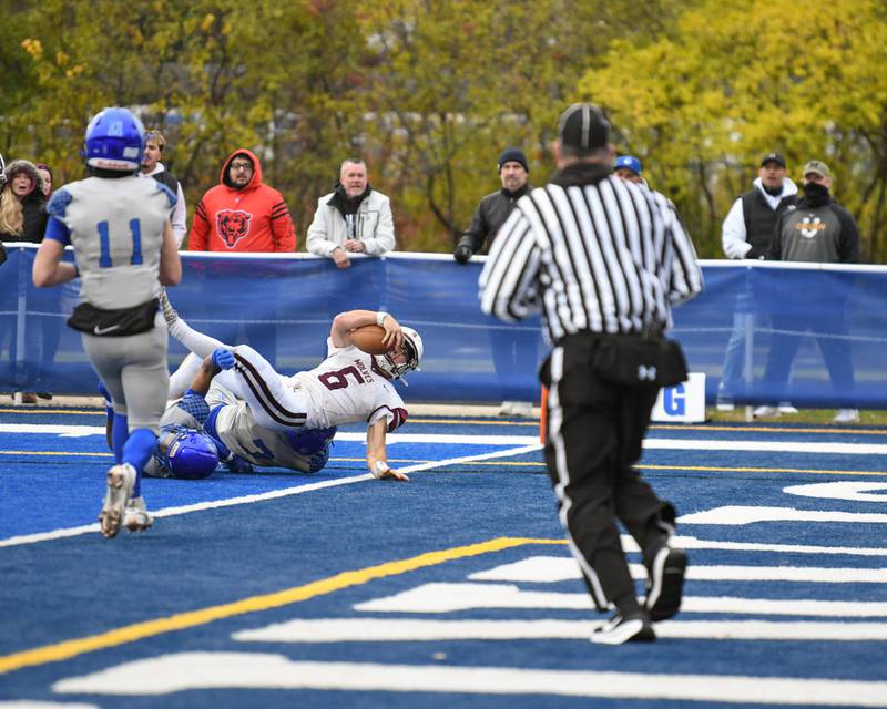 Prairie Ridge's Luke Vanderwiel (6) falls into the endzone while being defended by St. Francis’s defenders during the second round of the 5A playoff game on Saturday Nov. 8, 2025, held at St. Francis's High School.
