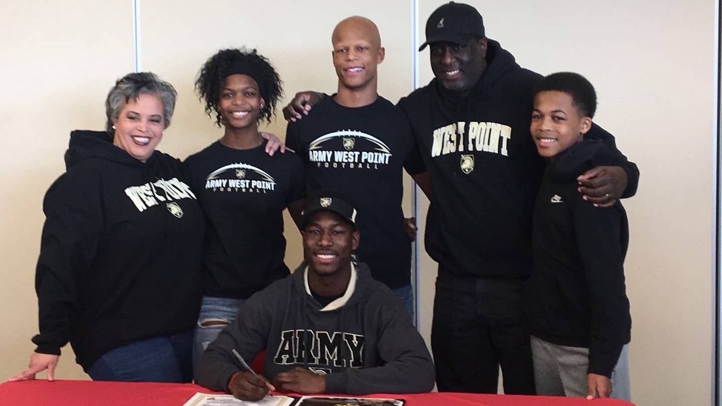 Nicole Walters (from left), Kayla, Justin, Horace Walters and Damon stand behind Brendon during his signing day ceremony.