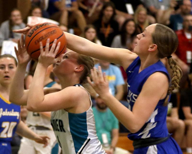 Woodstock North's Caylin Stevens drives to the basket as Woodstock’s Addy Walker tries to block the shot during the girl’s game of McHenry County Area All-Star Basketball Extravaganza on Sunday, April 14, 2024, at Alden-Hebron’s Tigard Gymnasium in Hebron.