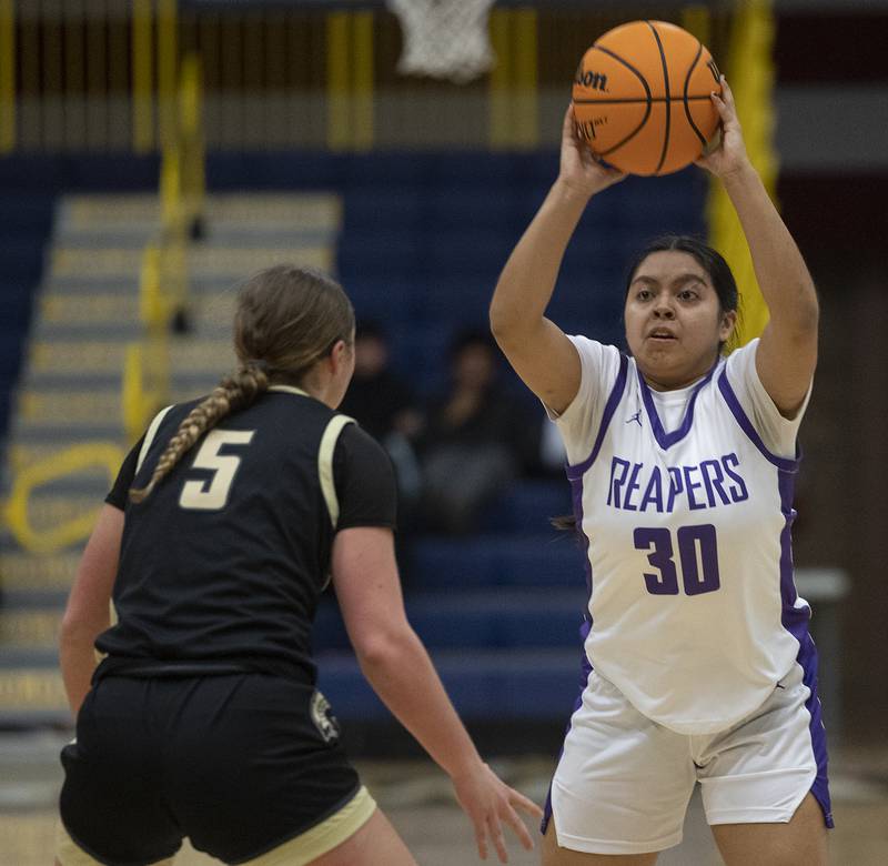 Plano’s Cami Nunez looks to pass while being guarded by Sycamore’s Grace Amptmann Monday, Feb. 17, 2025, during a 3A semifinal in Sterling.