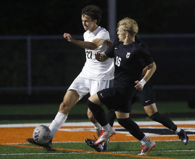 Prairie Ridge's Carter Favia kicks the ball away from McHenry's Cody Bundy during a Fox Valley Conference boys soccer match on Tuesday, Sept. 30, 2025, at McCracken Field in McHenry.