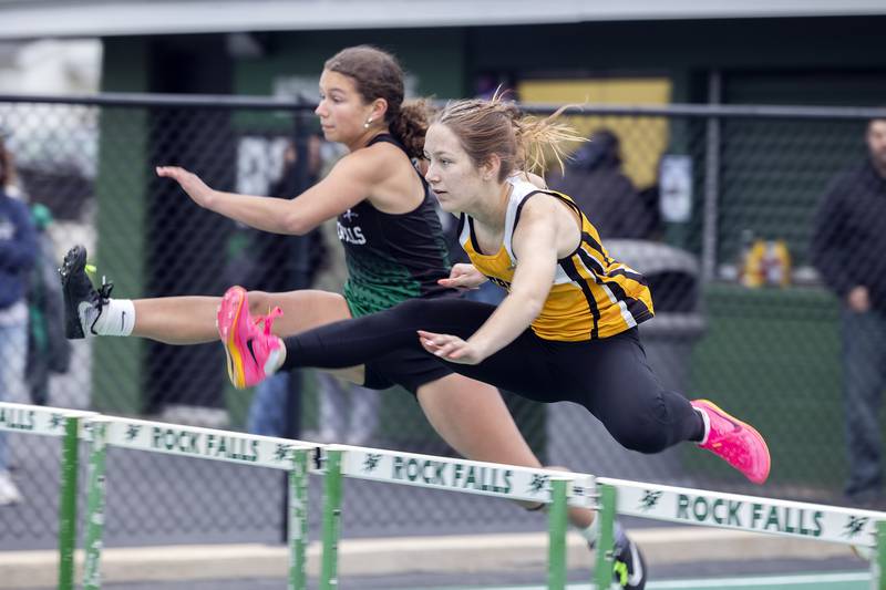 Rock Falls’ Elizabeth Lombardo and Riverdale’s Kaylee Overton clear the first hurdle in the 100 hurdles Friday, April 25, 2025, during the Rock Falls Rocket Invite.