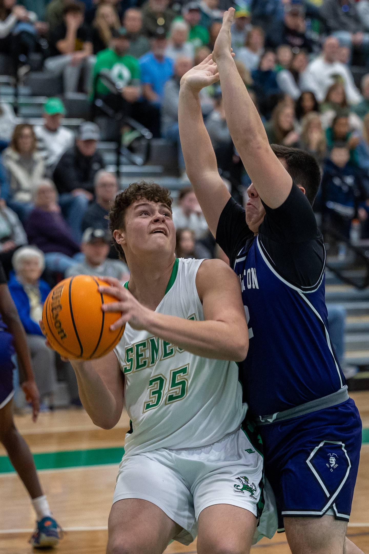 Zeb Maxwell of Seneca holds ball whilst being guarded by Lexington player on Saturday, December 28, 2024 at Seneca High School in Seneca.