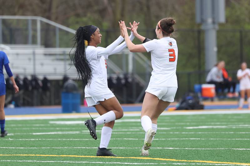 Plainfield East’s Kessiah Purnell, left, celebrates her goal with teammate Ava Graske against Joliet Central on Thursday, April 11, 2024.