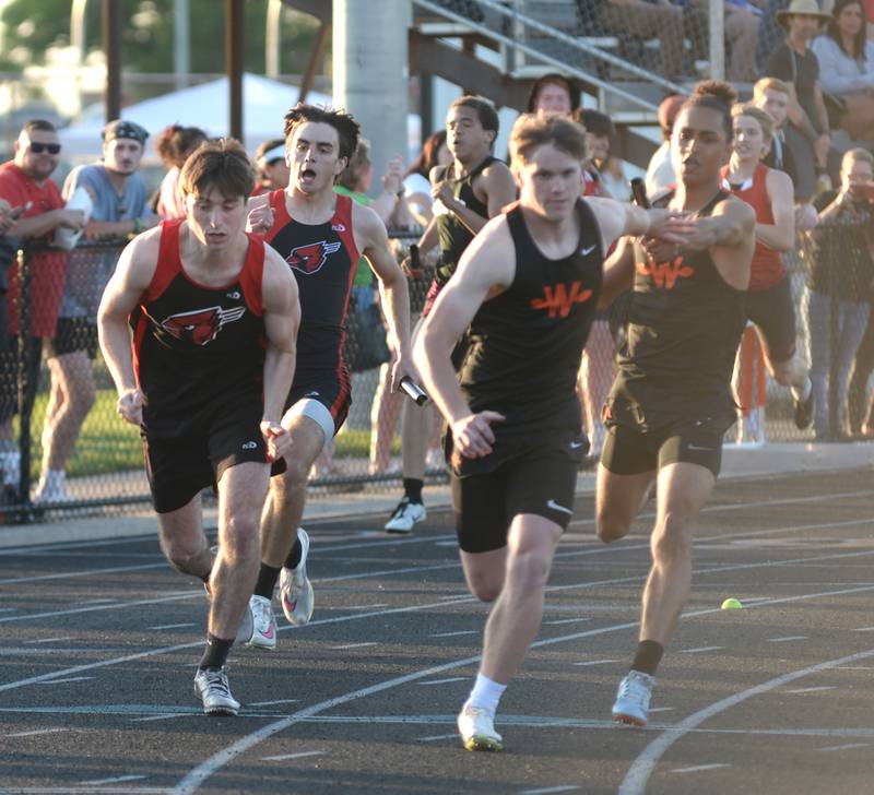 Forreston's Micah Nelson gets ready to hand the baton to Brock Soltow (left) during an exchange  in the 4x200 relay at the 1A Winnebago Sectional on Friday, May 17, 2024 in Winnebago. The Cardinals finished second in the event to qualify for the state finals at Eastern Illinois University in Charleston.