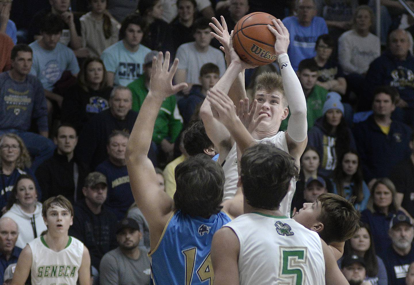 Marquette Christmas Tournament MVP Paxton Giertz takes a shot over the Crusaders' Alex Graham in Thursday's championship game in Ottawa.