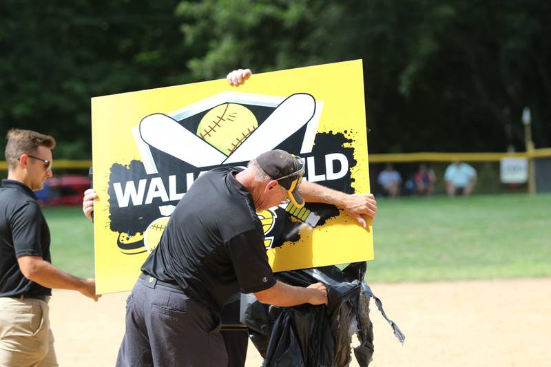 Chris Walker unveils the sign for Saturday's field dedication in his honor at PCJH.