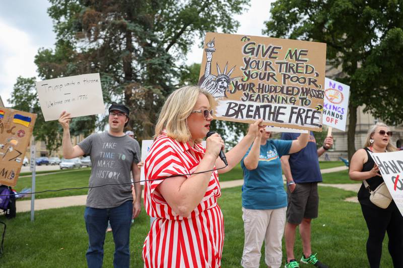 Katie Bretzlaff, of Kankakee, holds a sign and leads a chant as approximately 500 people gathered at the Kankakee County Courthouse for a ‘No Kings’ rally in Kankakee on Saturday, June 14, 2025, to protest actions by President Donald Trump.