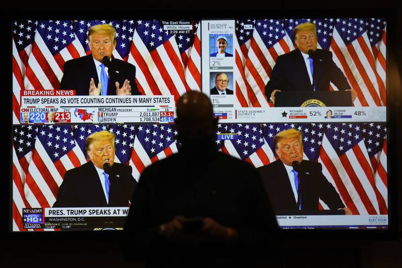 FILE - A live broadcast of President Donald Trump speaking from the White House is shown on screens at an election-night party, Nov. 3, 2020, in Las Vegas. Former President Donald Trump sought to "defraud the United States" by interfering with the presidential election, spreading false information about it and pressuring state officials to overturn the results, the congressional committee investigating the U.S. Capitol insurrection alleged in a federal court filing on March 2, 2022. (AP Photo/John Locher, File)