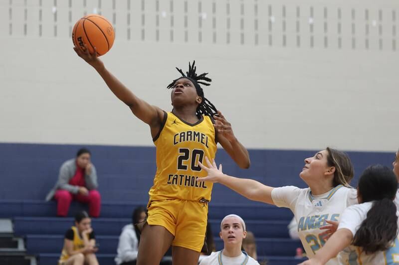 Carmel’s Ayo Akingbesote lays in a shot against Joliet Catholic on Wednesday, Jan 15, 2025 in Joliet.