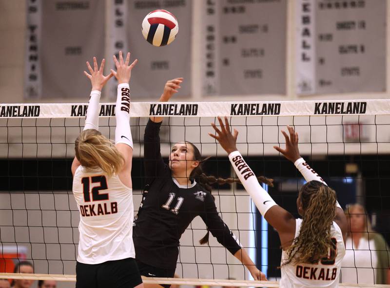 Kaneland's Natalie Remsen tries to tip the ball over DeKalb's Isabelle Smith (left) Zora Watts Thursday, Sept. 4, 2025, during their match at Kaneland High School in Maple Park.