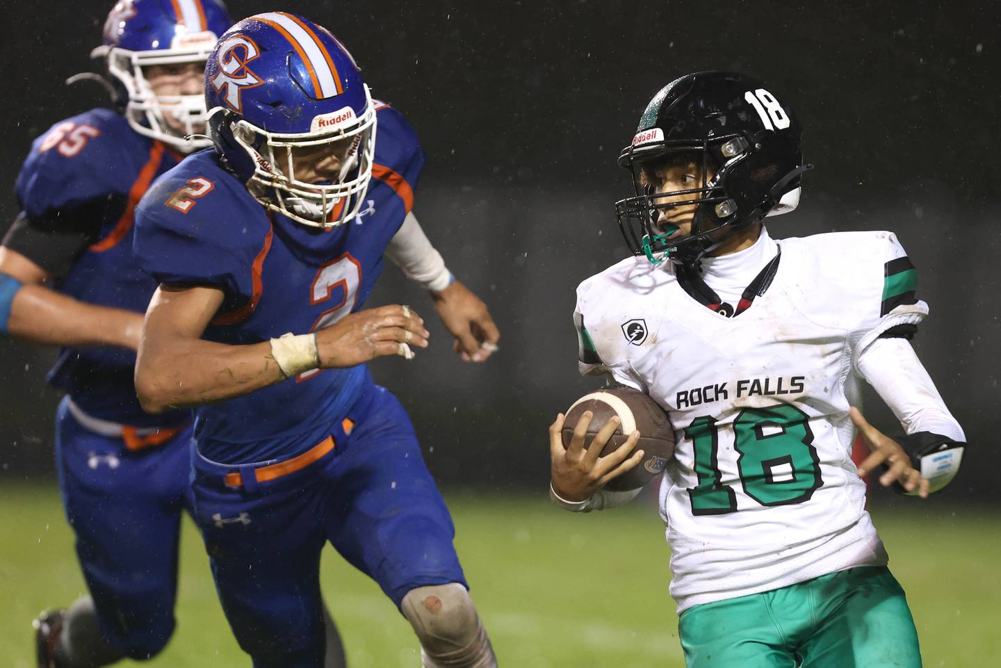 Rock Falls' Michael Flowers carries the ball with Genoa-Kingston's Tyler Atterberry and Ryan Swider in pursuit during their game Friday, Oct. 13, 2023, at Genoa-Kingston High School.