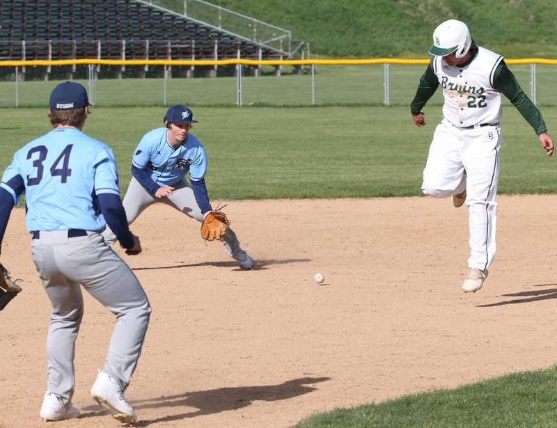 Bureau Valley's Sam Rouse (center) fields a ground ball as St. Bede's Alan Spencer runs to third base on Monday, May 1, 2023 at St. Bede Academy.
