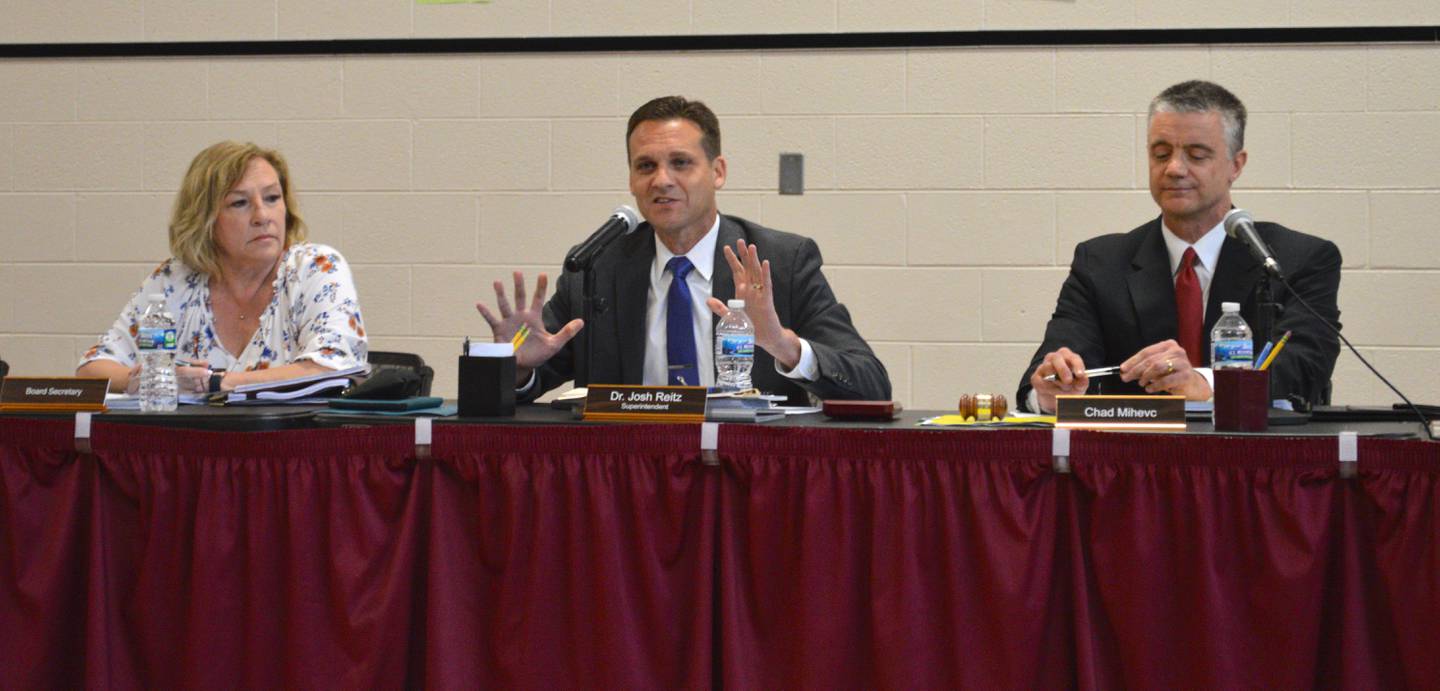 McHenry Elementary District 15 Superintendent Josh Reitz, center, presented the school system's plan to have students return to classes with masks optional and pre-pandemic classroom densities to the school board, including board President Chad Mihevc, right, on Wednesday, July 14, 2021.