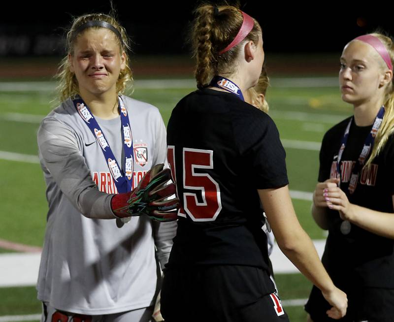 Barrington's Megan Holland pats her teammate Barrington's Kate Lubinsky one the back after Barrington lost to O'Fallon in overtime in the IHSA Class 3A state championship match at North Central College in Naperville on Saturday, June 3, 2023.
