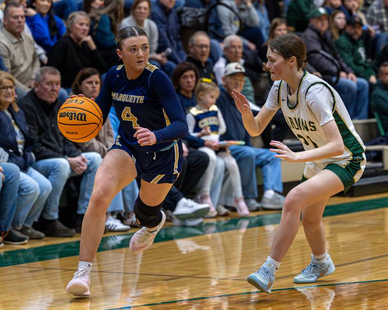 Hunter Hopkins (4) of Marquette dribbles ball down court whilst being guarded by Parker McClain (21) of St. Bede on Friday, January 16, 2026 at St. Bede Academy in Peru.